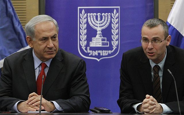 Prime Minister Benjamin Netanyahu and Likud member Yariv Levin are seen during a faction meeting at the Knesset on December 9, 2013. (Miriam Alster/Flash90)