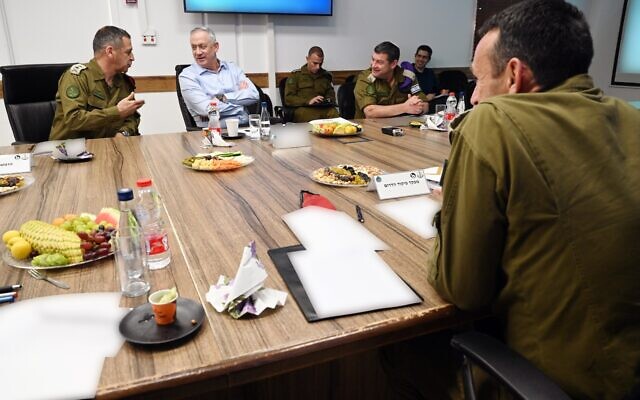 Defense Minister Benny Gantz, center, meets with IDF Chief of Staff Aviv Kohavi, left, and head of the Southern Command Herzi Halevi, right, in southern Israel on May 26, 2020. (Ariel Hermoni/Defense Ministry)