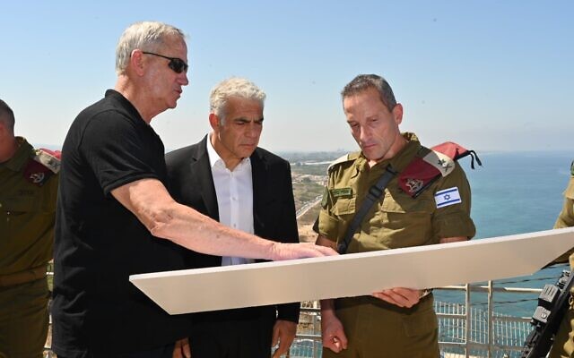 Defense Minister Benny Gantz (right) Prime Minister Yair Lapid (center) and Northern Command chief Amir Baram on the Lebanese border, near the coast, on July 19, 2022. (Amos Ben Gershom/GPO)
